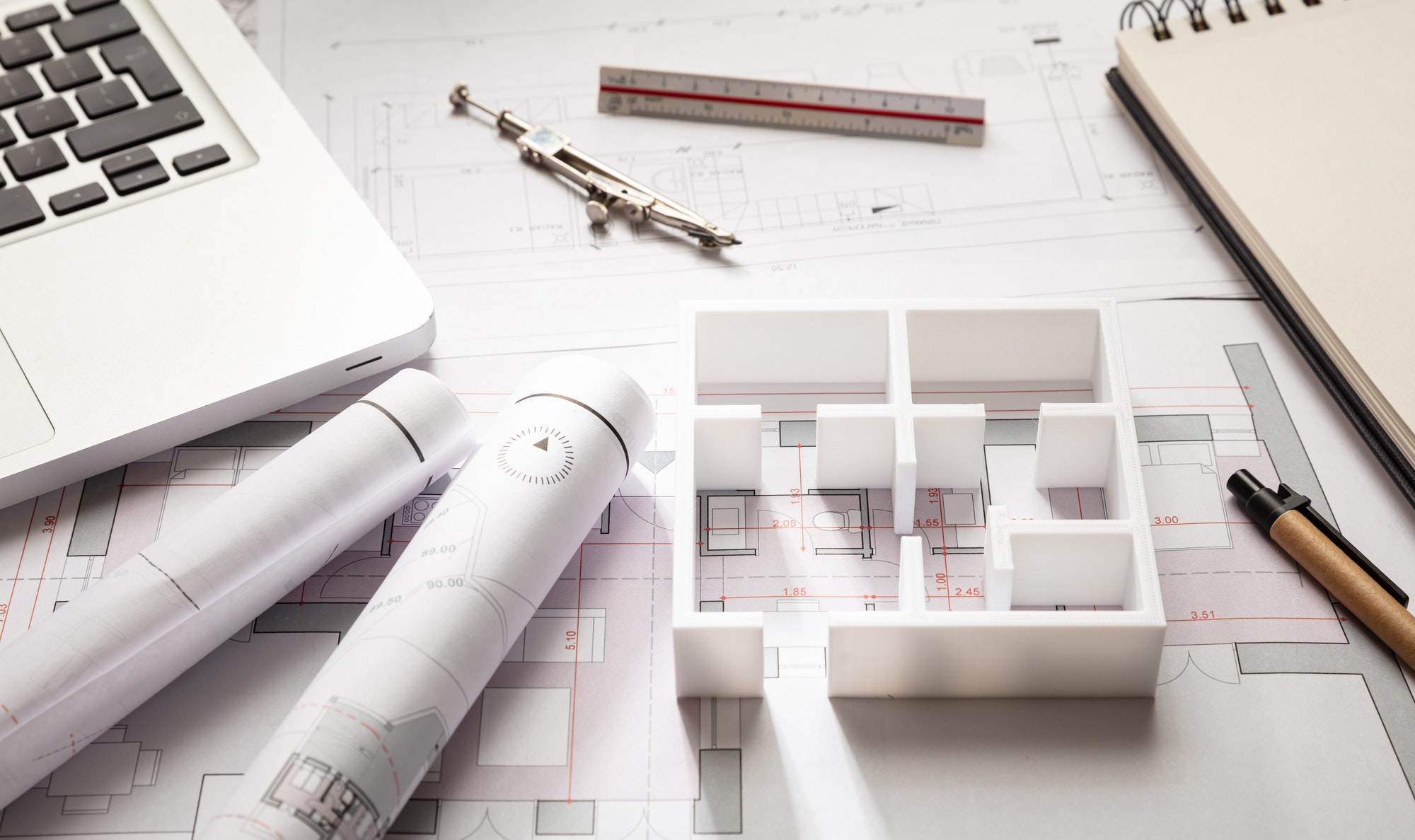 Construction concept: residential building drawings and a house model